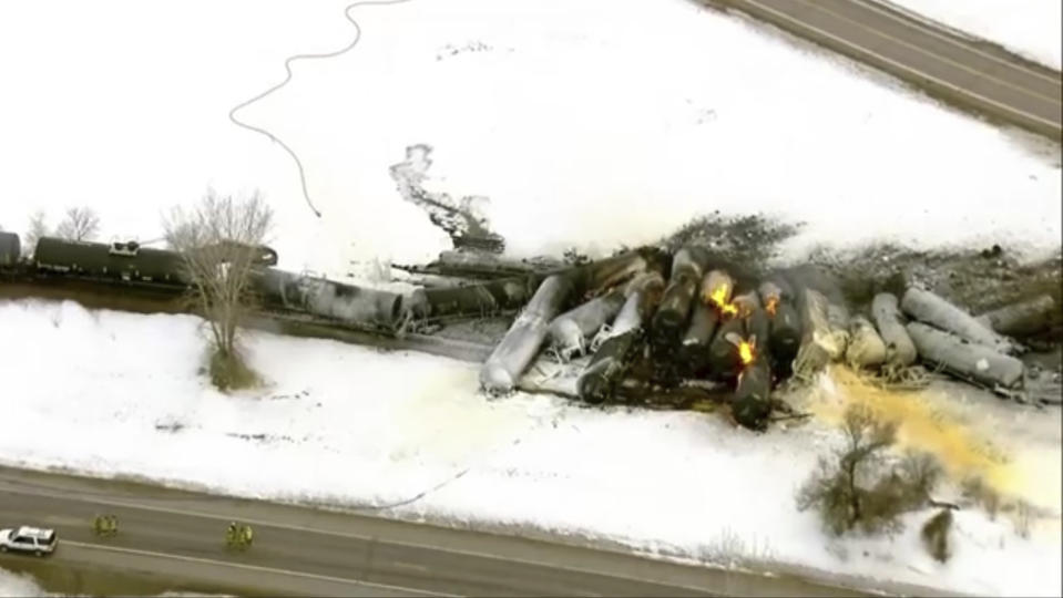 This photo provided KSTP, emergency personnel respond to the scene of a train derailment early Thursday, March 30, 2023 in Raymond, Min. A train hauling ethanol and corn syrup derailed and caught fire and nearby residents were ordered to evacuate their homes, authorities said. (KSTP via AP)