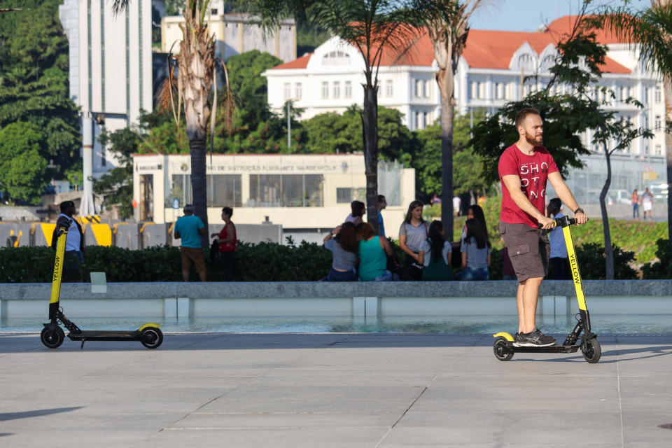 Brazilian cities adopt legislation contrary to the use of electric scooters after the increase of accidents and abuses of users of the system. In the cities of Rio and São Paulo, users drop off electric scooters anywhere, disrupting the passage of pedestrians and people with disabilities and also causing accidents. With this, the main Brazilian cities have started to create rules of use that require the use of helmets and even that the users do a test of habilitation to be able to direct the electric vehicles. In this image: Child uses Yellow's electric scooter to get around the Museum of Tomorrow in Downtown Rio. (Photo by Luiz Souza/NurPhoto via Getty Images)