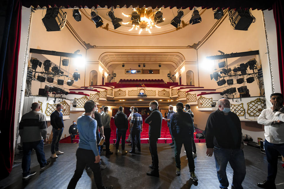 Inmates arrive for the final rehearsal for the State of Siege, by French author Albert Camus, a play describing the arrival of plague in Spain which brings a totalitarian regime to power, at the Nottara Theatre in Bucharest, Romania, Wednesday, Nov. 24, 2021. (AP Photo/Andreea Alexandru)