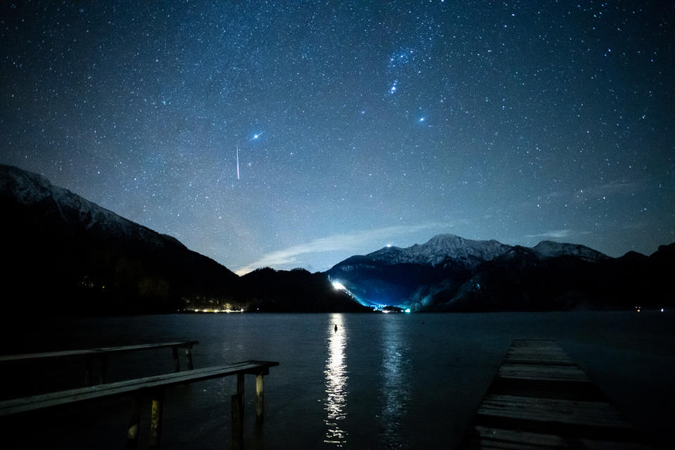 14 December 2020, Bavaria, Kochel Am See: A shooting star can be seen during the Geminids meteor stream in the starry sky above the Kochelsee between the peaks of the Jochberg (l) and the Herzogstand. The Geminids  are the strongest meteor stream of the year. Photo: Matthias Balk/dpa (Photo by Matthias Balk/picture alliance via Getty Images)