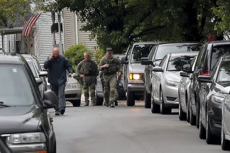 Law enforcement officials are gathered on a residential street in Everett, Massachusetts June 2, 2015 in connection to a man shot dead by law enforcement in Boston after coming at them with a large knife when they tried to question him as part of a terrorism-related investigation, authorities said. REUTERS/Brian Snyder