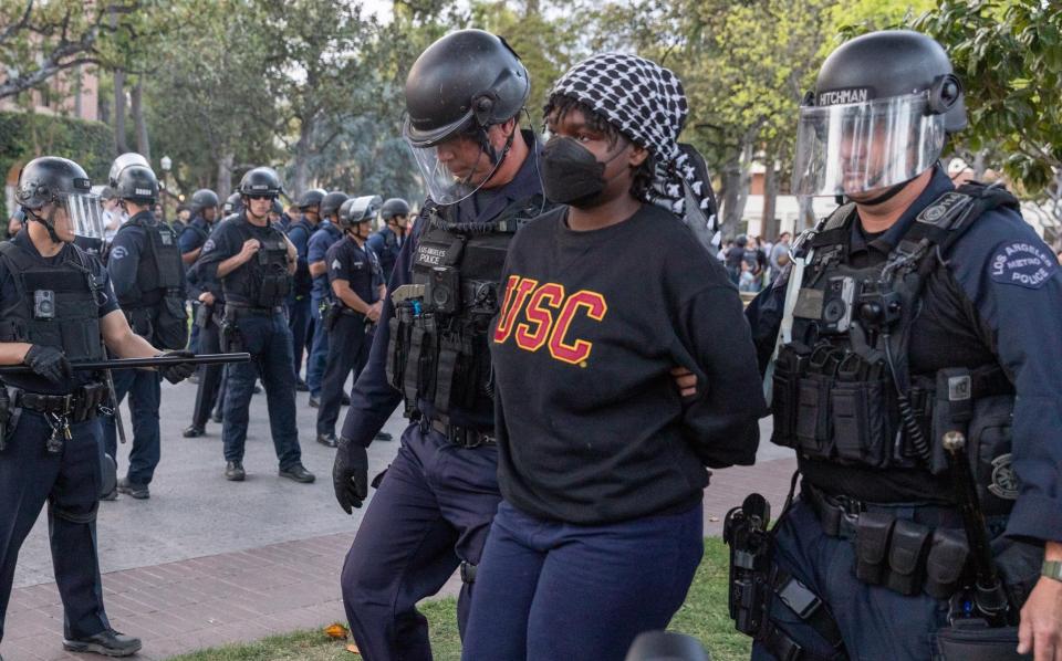Members of the law enforcement and police officers intervene the Pro-Palestinian student protesters as they gather to protest Israel attacks over Gaza, at University of Southern California in Los Angeles, California