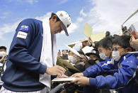 Japanese pitcher Roki Sasaki signs autographs for fans at a camp of WBC Japan team in Miyazaki, southern Japan, on Feb. 19, 2023. All eyes will be on Japanese baseball pitcher Sasaki at the World Baseball Classic. He is regarded as the next big thing in baseball out of Japan. (Kyodo News via AP)