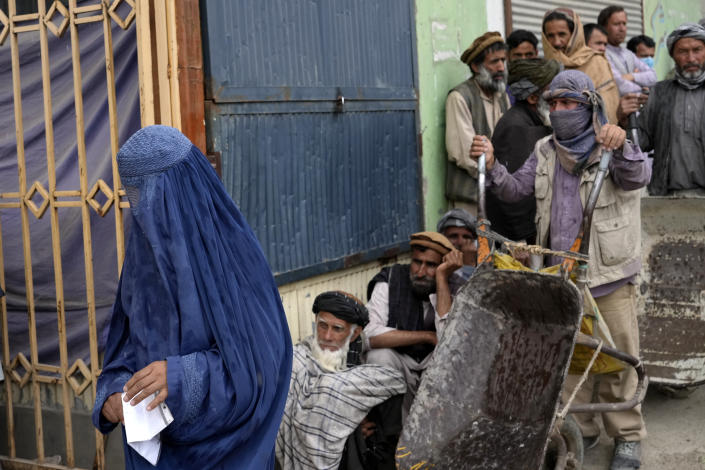 FILE - People wait to receive food rations distributed by a South Korean humanitarian aid group, in Kabul, Afghanistan, May 10, 2022. (AP Photo/Ebrahim Noroozi, File)