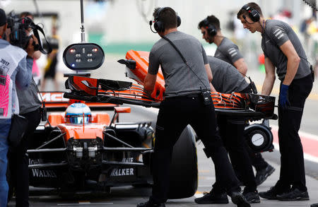 Formula One - F1 - Australian Grand Prix - Melbourne, Australia - 24/03/2017 McLaren driver Fernando Alonso of Spain has his car's nose cone changed in the pits during the first practice session. REUTERS/Brandon Malone