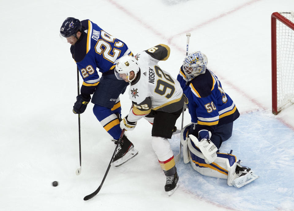 St. Louis Blues' Vince Dunn (29) and Vegas Golden Knights' Tomas Nosek (92) battle in front as Blues goalie Jordan Binnington (50) looks for the shot during second-period NHL hockey playoff game action in Edmonton, Alberta, Thursday, Aug. 6, 2020. (Jason Franson/The Canadian Press via AP)