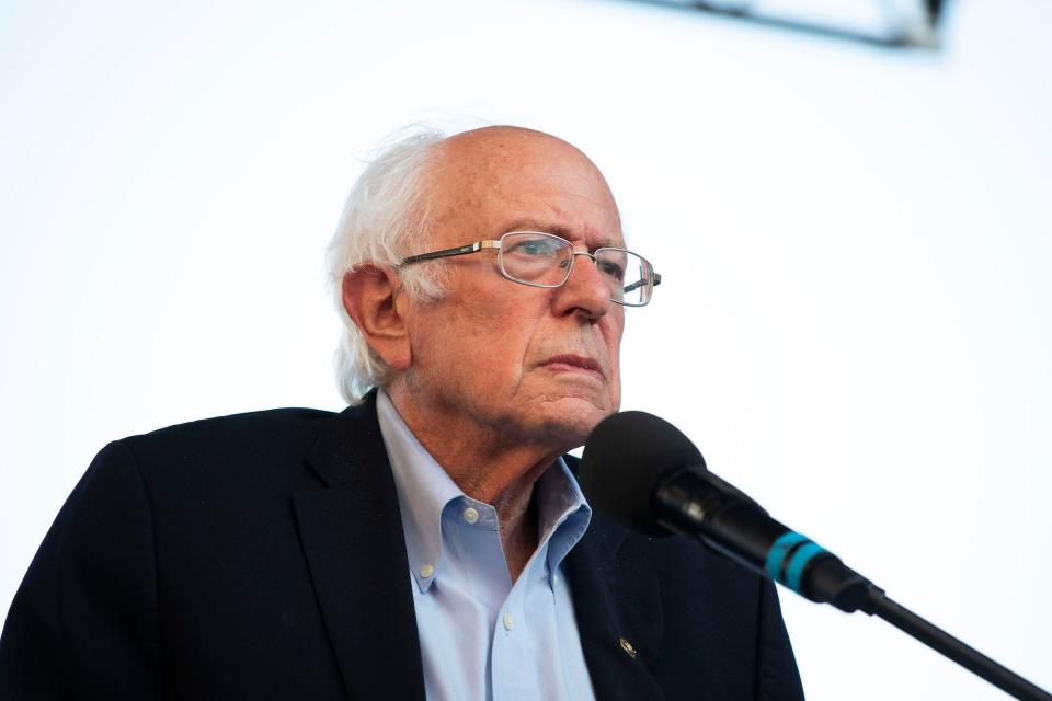 Independent Sen. Bernie Sanders of Vermont, sporting glasses and a dark suit jacket, speaks at a campaign rally for Michigan Democratic Reps. Andy Levin and Rashida Tlaib on July 29, 2022 in Pontiac, Michigan.