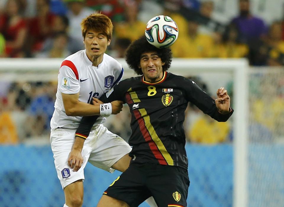 South Korea's Ki fights for the ball with Belgium's Fellaini during their 2014 World Cup Group H soccer match at the Corinthians arena in Sao Paulo