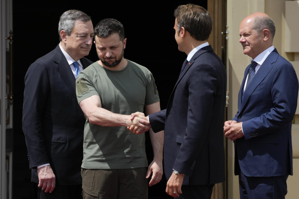 Ukrainian President Volodymyr Zelenskyy, second left, shake hands with French President Emmanuel Macron, as they are flanked by Italian Prime Minister Mario Draghi, left, and German Chancellor Olaf Scholz, at the Mariyinsky Palace in Kyiv, Ukraine, Thursday, June 16, 2022. Four European leaders, of France, Italy, Germany and Romania, made a high-profile visit to Ukraine, where they were saw the ruins of a Kyiv suburb on Thursday and denounced the brutality of a Russian invasion that has killed many civilians. (AP Photo/Natacha Pisarenko)