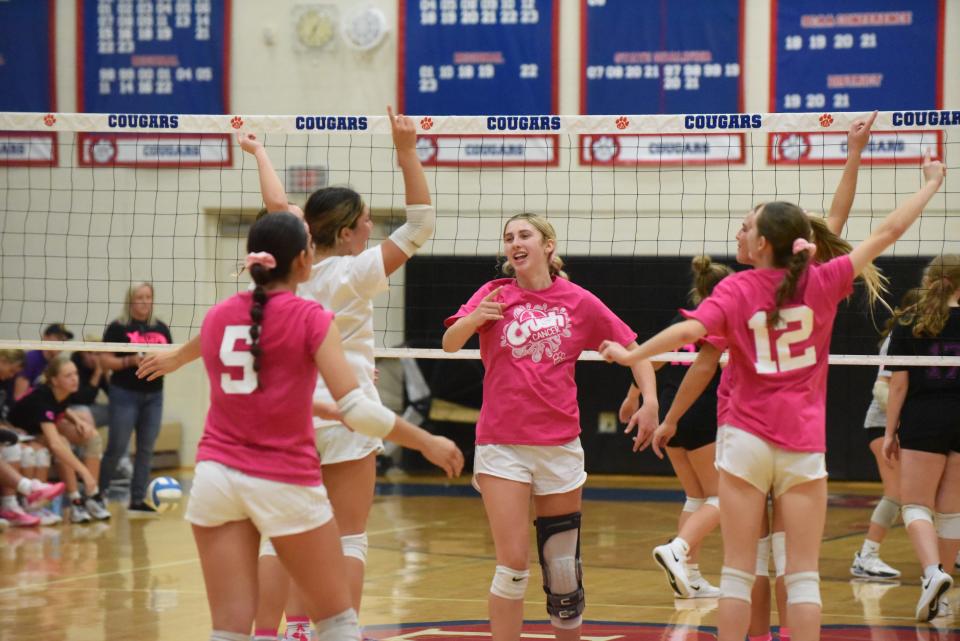 The Lenawee Christian volleyball team celebrates a point during a match against Sand Creek.