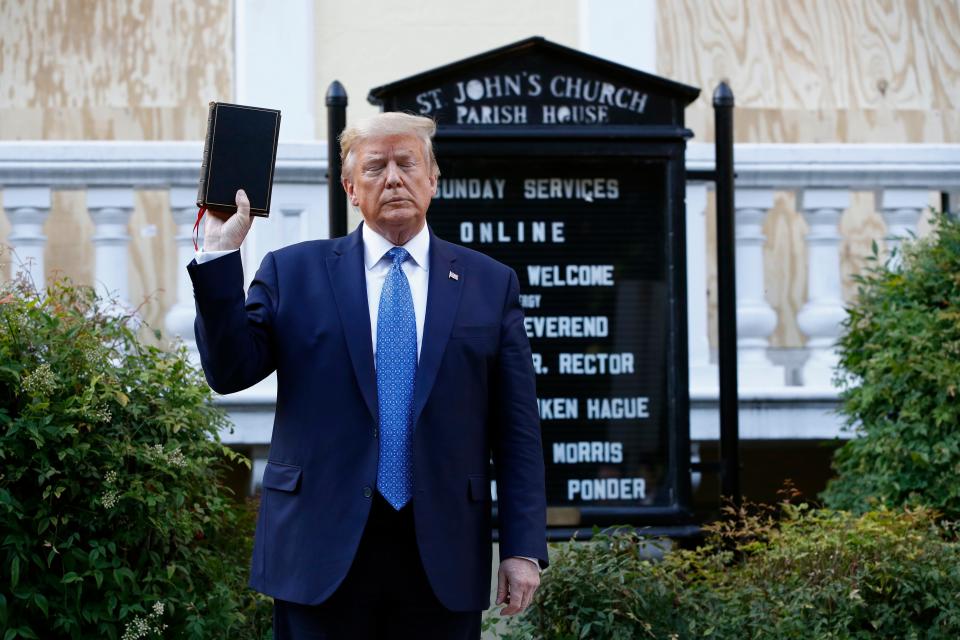 President Donald Trump holds a Bible as he visits outside St. John's Church across Lafayette Park from the White House Monday, June 1, 2020, in Washington. 