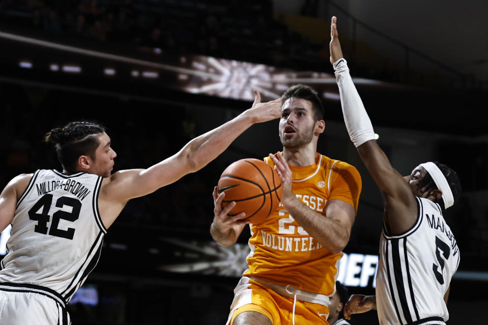 Tennessee guard Santiago Vescovi (25) shoots past Vanderbilt guard Ezra Manjon (5) and forward Quentin Millora-Brown (42) during the first half of an NCAA college basketball game Wednesday, Feb. 8, 2023, in Nashville, Tenn. (AP Photo/Wade Payne)