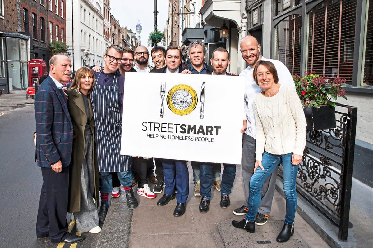 Out in the streets: William Sieghart, left, along with many of the charity’s longstanding supporters    (Courtesy of Streetsmart)