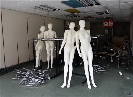 Mannequins stand in a closed clothes shop in Derby, central England, in this September 8, 2009 file picture. REUTERS/Darren Staples/Files