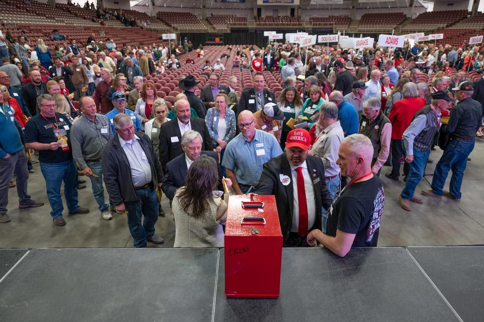 Delegates file their ballots for Colorado District 4 candidates during the Colorado Republican State Assembly at the Southwest Motors Events Center on Friday, April 5, 2024.