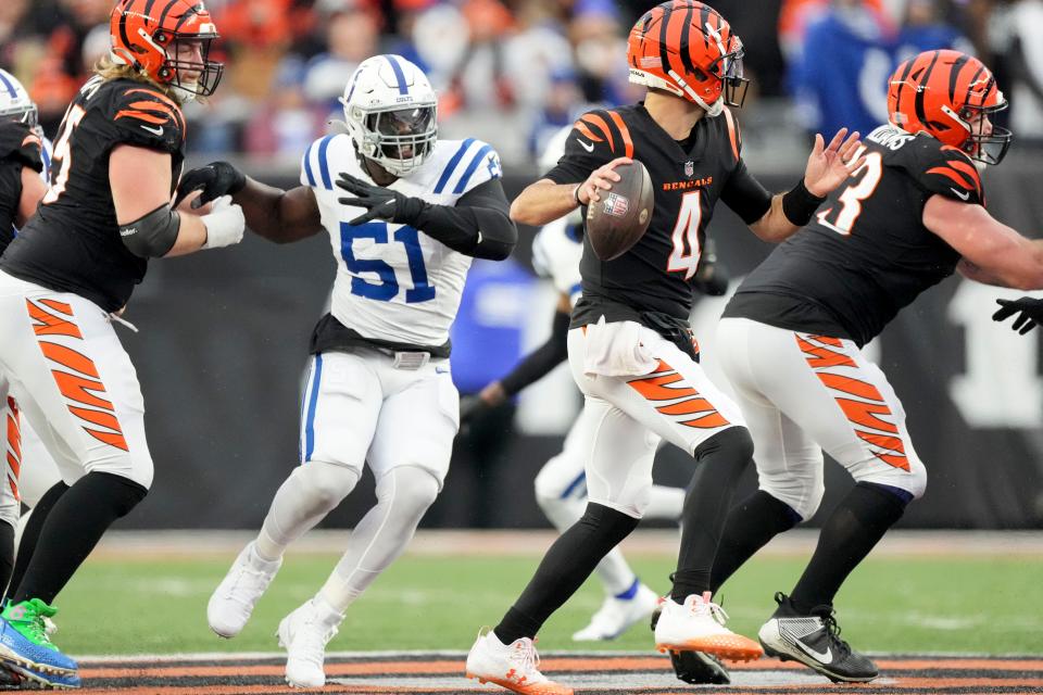 Indianapolis Colts defensive end Kwity Paye (51) moves in as Cincinnati Bengals quarterback AJ McCarron (4) draws back to pass Sunday, Dec. 10, 2023, during a game against the Cincinnati Bengals at Paycor Stadium in Cincinnati.