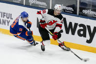 New York Islanders' Mathew Barzal (13) defends against New Jersey Devils' Kevin Bahl (88) during the third period of an NHL hockey game Thursday, May 6, 2021, in Uniondale, N.Y. The Devils won 2-1. (AP Photo/Frank Franklin II)