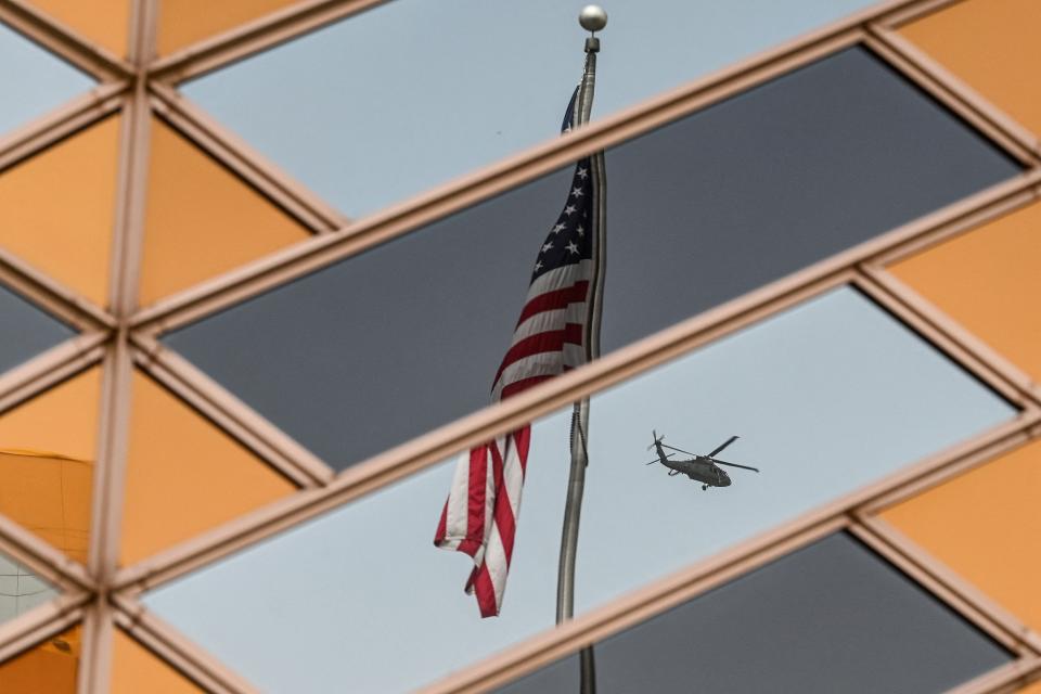 The US national flag is reflected on the windows of the US embassy building in Kabul on July 30, 2021.  The United States said on August 12, 2021 it was sending troops to the international airport in Afghanistan's capital Kabul to pull out US embassy staff as the Taliban makes rapid gains.