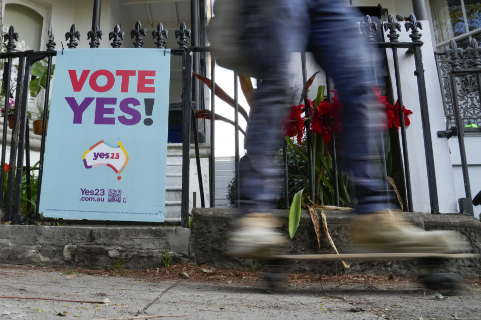 A skater boarder passes a vote Yes poster for the Voice referendum in Sydney, Australia, Monday, Sept. 11, 2023. Voters can apply from Monday for postal ballots in the Oct. 14 referendum that would create a so-called Indigenous Voice to Parliament, a proposal for constitutional change that opinion polls suggest is becoming increasingly likely to be rejected. (AP Photo/Mark Baker)