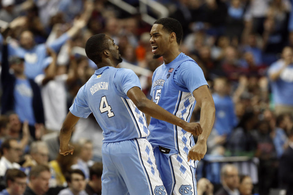 North Carolina guard Brandon Robinson (4) and forward Garrison Brooks (15) react during the second half of an NCAA college basketball game against Virginia Tech at the Atlantic Coast Conference tournament in Greensboro, N.C., Tuesday, March 10, 2020. (AP Photo/Ben McKeown)