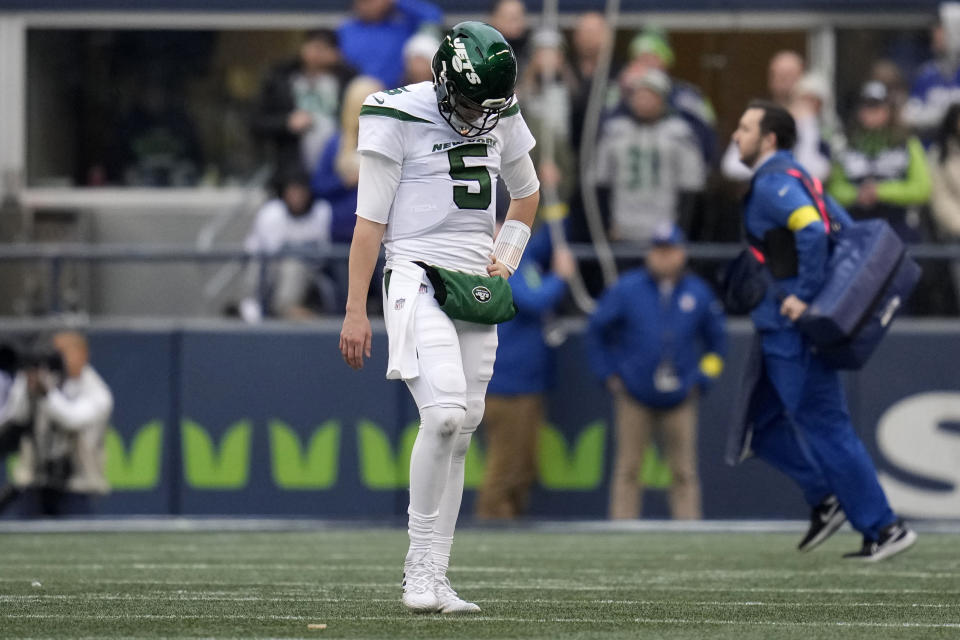 New York Jets quarterback Mike White (5) walks toward his bench at the end of the first half of an NFL football game against the Seattle Seahawks, Sunday, Jan. 1, 2023, in Seattle. (AP Photo/Godofredo A. Vásquez)