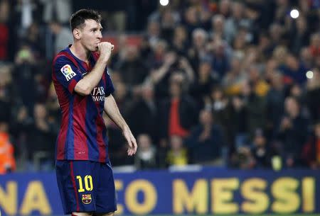 Barcelona's Lionel Messi celebrates his second goal during the Spanish first division soccer match against Sevilla at Nou Camp stadium in Barcelona November 22, 2014. REUTERS/Gustau Nacarino