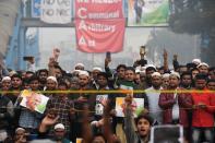 Protesters hold placards and shout slogans at a demonstration against Indias new citizenship law in New Delhi on December 20, 2019. - Fresh clashes between Indian police and demonstrators erupted on December 20 after more than a week of deadly unrest triggered by a citizenship law seen as anti-Muslim. (Photo by Prakash SINGH / AFP) (Photo by PRAKASH SINGH/AFP via Getty Images)