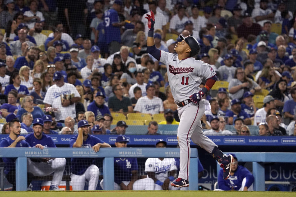 Minnesota Twins' Jorge Polanco gestures before scoring after hitting a three-run home run during the third inning of a baseball game against the Los Angeles Dodgers Wednesday, Aug. 10, 2022, in Los Angeles. (AP Photo/Mark J. Terrill)