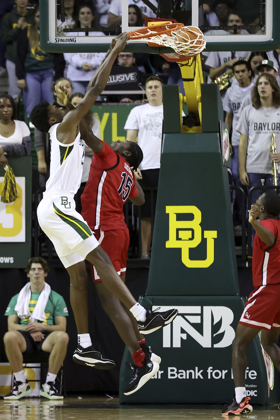 Baylor center Yves Missi, left, dunks past Gardner-Webb forward Cheickna Sissoko (15) in the first half of an NCAA college basketball game, Sunday, Nov. 12, 2023, in Waco, Texas. (AP Photo/Jerry Larson)