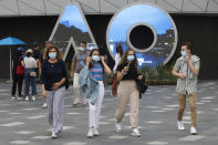 Masked spectators arrive for the first round matches at the Australian Open tennis championships in Melbourne, Australia, Monday, Jan. 17, 2022. (AP Photo/Hamish Blair)