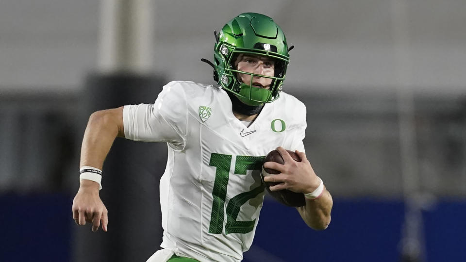 FILE - In this Dec 18, 2020, file photo, Oregon quarterback Tyler Shough (12) runs the ball during the first half of an NCAA college football game for the Pac-12 Conference championship against Southern California in Los Angeles. Shough transferred to Texas Tech. (AP Photo/Ashley Landis, File)