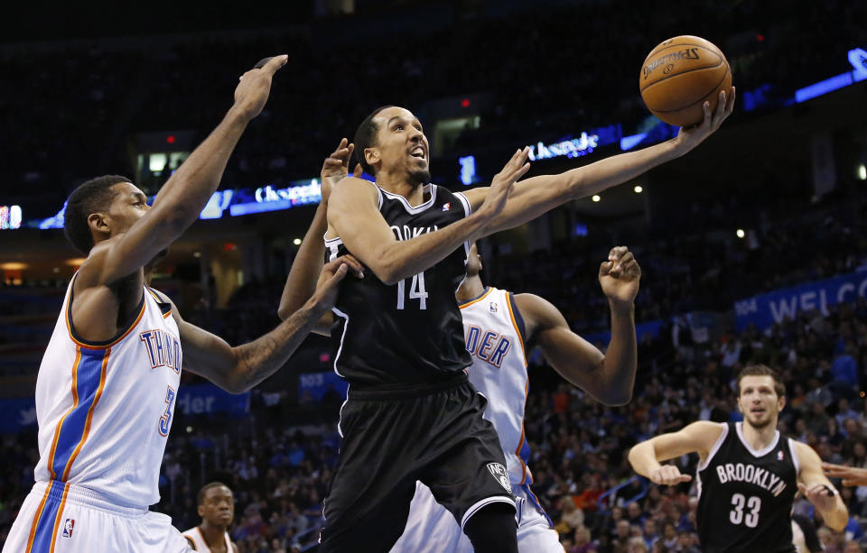 Brooklyn Nets guard Shaun Livingston (14) shoots in front of Oklahoma City Thunder forward Perry Jones (3) and forward Serge Ibaka in the second quarter of an NBA basketball game in Oklahoma City, Thursday, Jan. 2, 2014. (AP Photo/Sue Ogrocki)