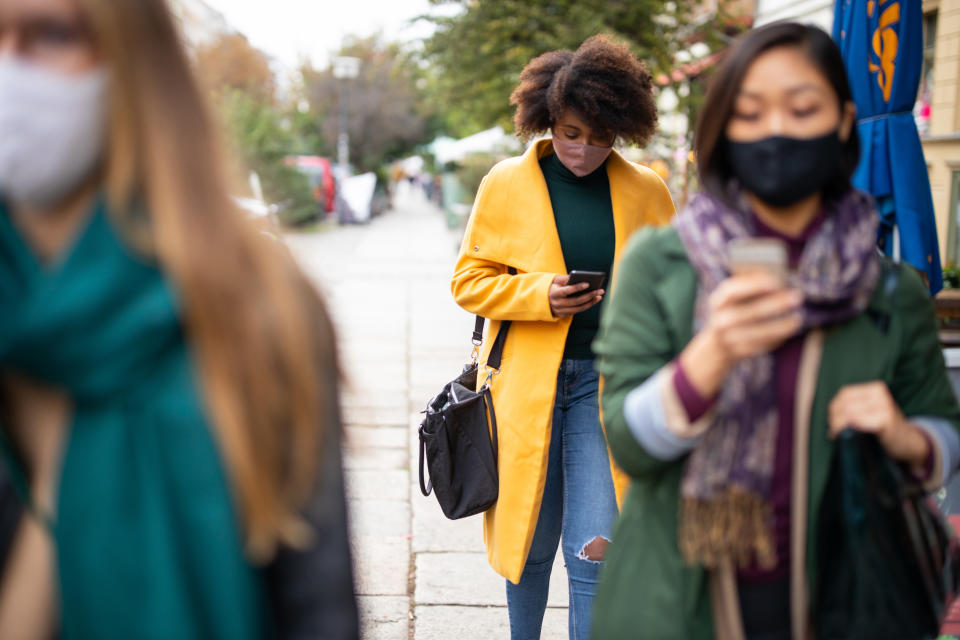 People commuting in the city wearing face masks. Source: Getty Images