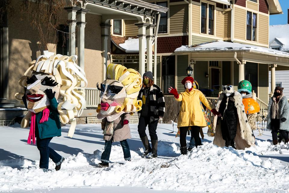People decked out in costumes, face masks and gloves participate in the Iowa City Joy March, Saturday, Jan. 15, 2022, in Iowa City, Iowa.