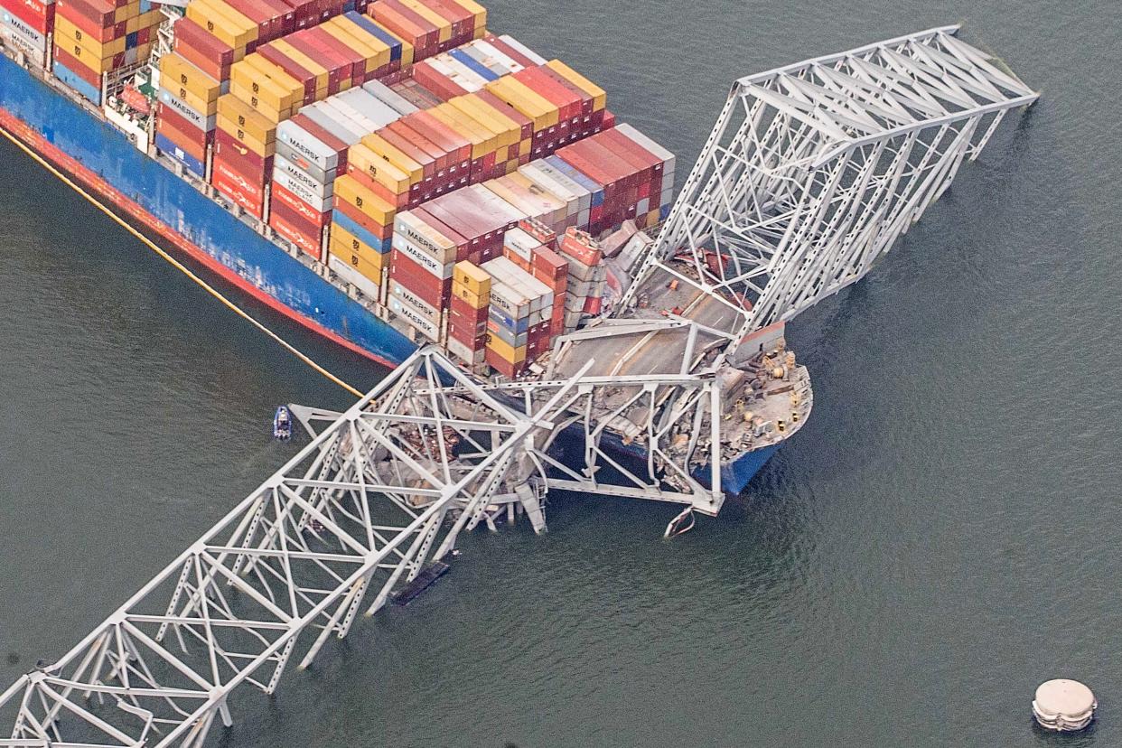 The container ship Dali is shown amidst the wreckage of the collapsed Francis Scott Key Bridge in Baltimore, Tuesday, March 26, 2024. Six people are missing after the Dali lost power and crashed into one of the bridge's support columns.