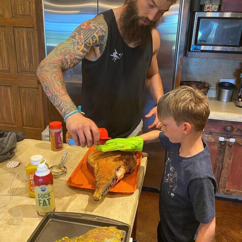 Carolina Hurricanes defenseman Brent Burns and his son Jagger season an axis deer ham for cooking. Burns, who has his own game farm in Texas, has hosted some of the Hurricanes’ younger players for dinner with his family.