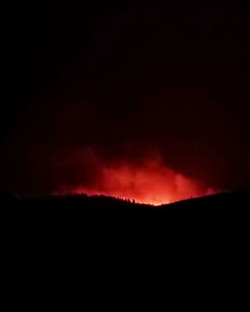 An amber glow from a wildfire is seen from Bondurant, Wyoming, United States in this September 22, 2018 photo by Jared Kail. Jared Kail/Social Media/via REUTERS