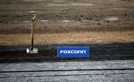 FILE PHOTO: A shovel and FoxConn logo are seen before the arrival of U.S. President Donald Trump as he participates in the Foxconn Technology Group groundbreaking ceremony for its LCD manufacturing campus, in Mount Pleasant, Wisconsin, U.S., June 28, 2018. REUTERS/Darren Hauck/File Photo