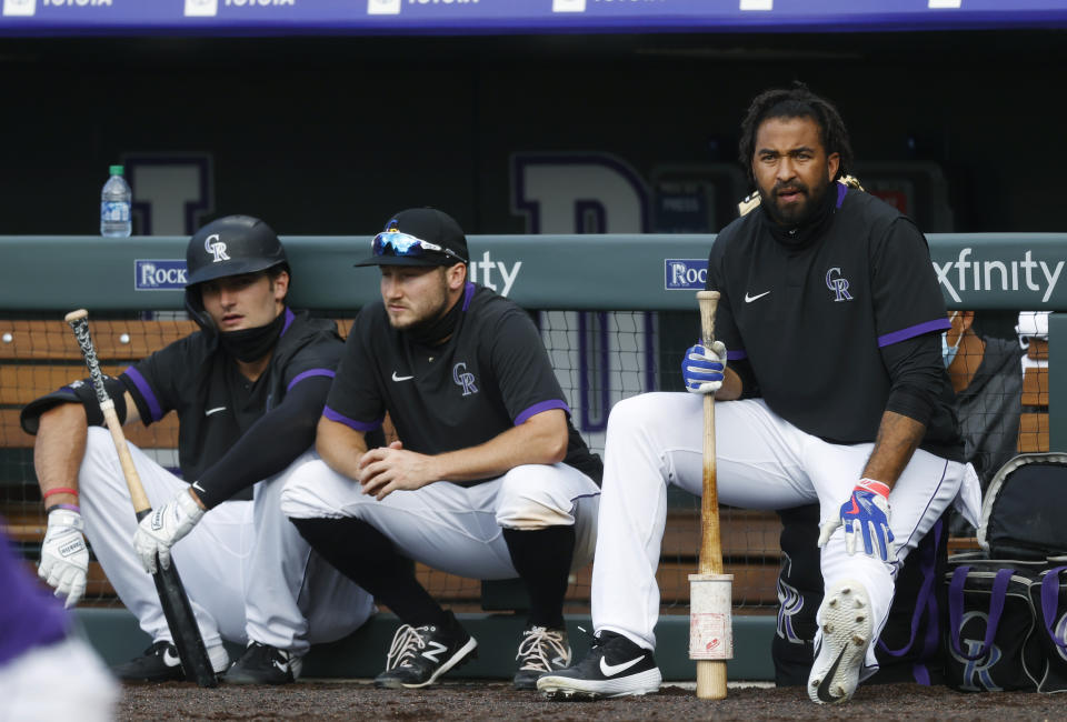 Colorado Rockies outfielder Matt Kemp, right, second baseman Garrett Hampson and right fielder Sam Hilliard wait to bat during the baseball team's practice Sunday, July 12, 2020, in Denver. (AP Photo/David Zalubowski)