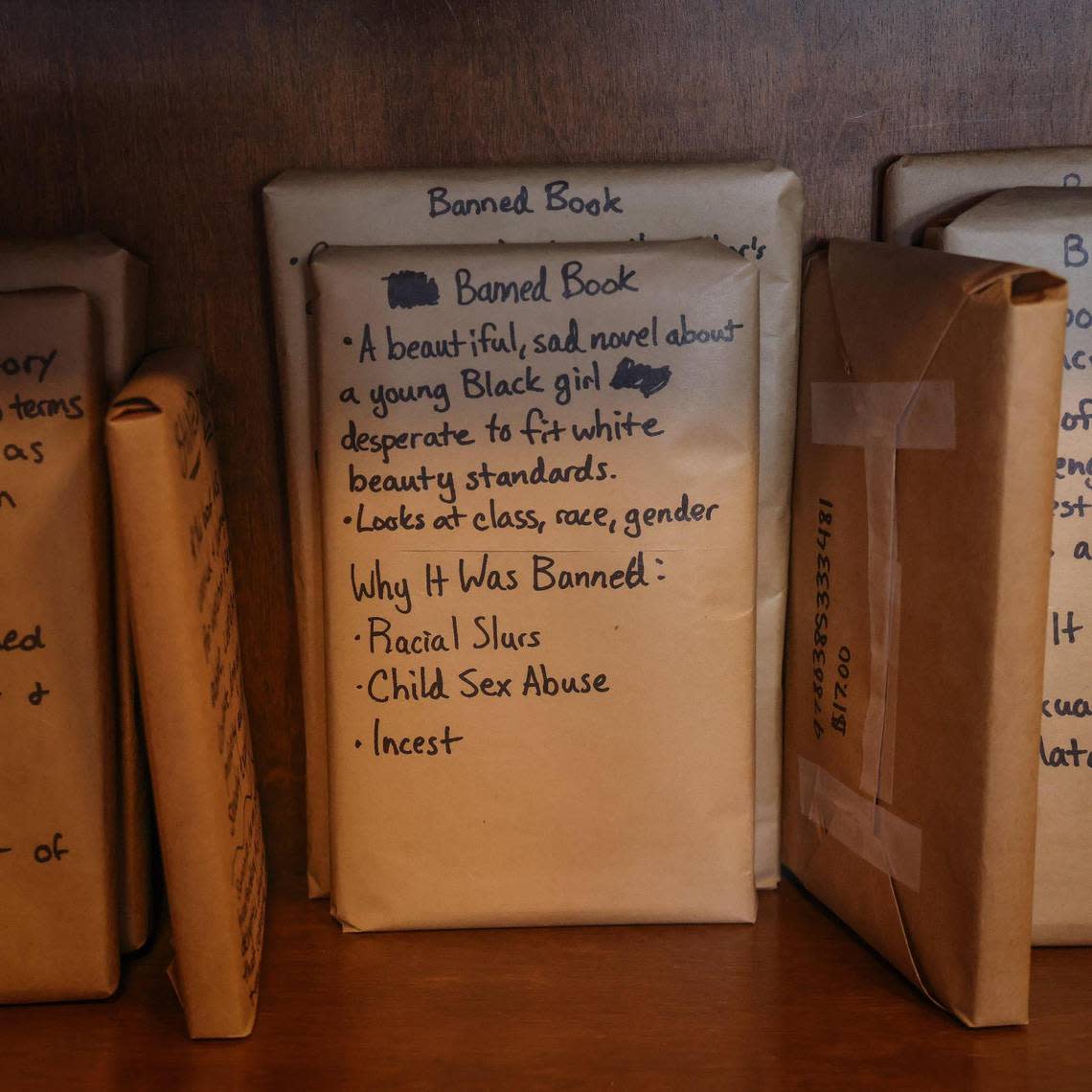 Books covered with brown paper are displayed with titles and reasons for their banning during the “Walk for Freadom” kickoff event on Sunday, October 1, 2023 in Coral Gables, Florida. The march began at the Coral Gables Congregational United Church of Christ and ended at Books & Books.