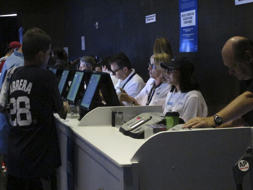 Workers at the FanDuel sports book at the Meadowlands Racetrack in East Rutherford N.J. take bets moments after it opened on July 14, 2018. On July 8, 2024, New Jersey gambling regulators revealed they had fined FanDuel $2,000 for taking bets in 2022 on mixed martial arts fights that had already happened a week earlier. (AP Photo/Wayne Parry)