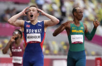 Karsten Warholm, of Norway celebrates as he wins the gold medal in the final of the men's 400-meter hurdles at the 2020 Summer Olympics, Tuesday, Aug. 3, 2021, in Tokyo, Japan. (AP Photo/Martin Meissner)