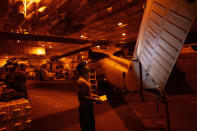 A crew member checks a helicopter in the hangar bay of the USS Dwight D. Eisenhower in the Red Sea on Tuesday, June 11, 2024.(AP Photo/Bernat Armangue)