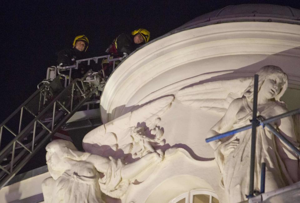 Emergency services look at the roof of the Apollo Theatre on Shaftesbury Avenue cafter part of the ceiling collapsed in central London