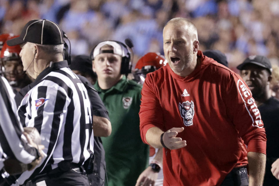 North Carolina State head coach Dave Doeren argues a call with an official during the second half of an NCAA college football game against North Carolina Friday, Nov. 25, 2022, in Chapel Hill, N.C. (AP Photo/Chris Seward)