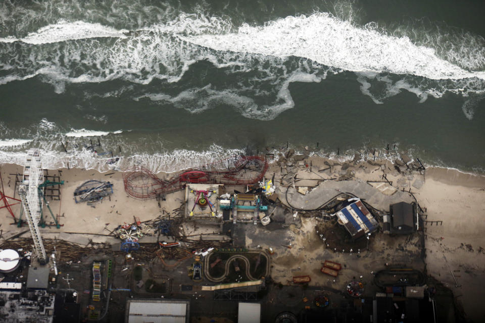 In this aerial photo, debris from an amusement park destroyed during Superstorm Sandy lines the beach in Seaside Heights, N.J. Thursday, Nov. 1, 2012.  The photo was taken during a flight to document coastal changes by the National Oceanic and Atmospheric Administration after the storm moved through the area. (AP Photo/Alex Brandon)