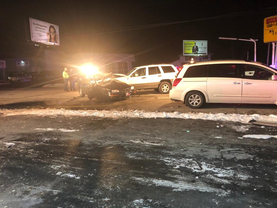 Authorities stand near the scene of a serious crash Friday night at McKinley and Byrkit avenues in Mishawaka.