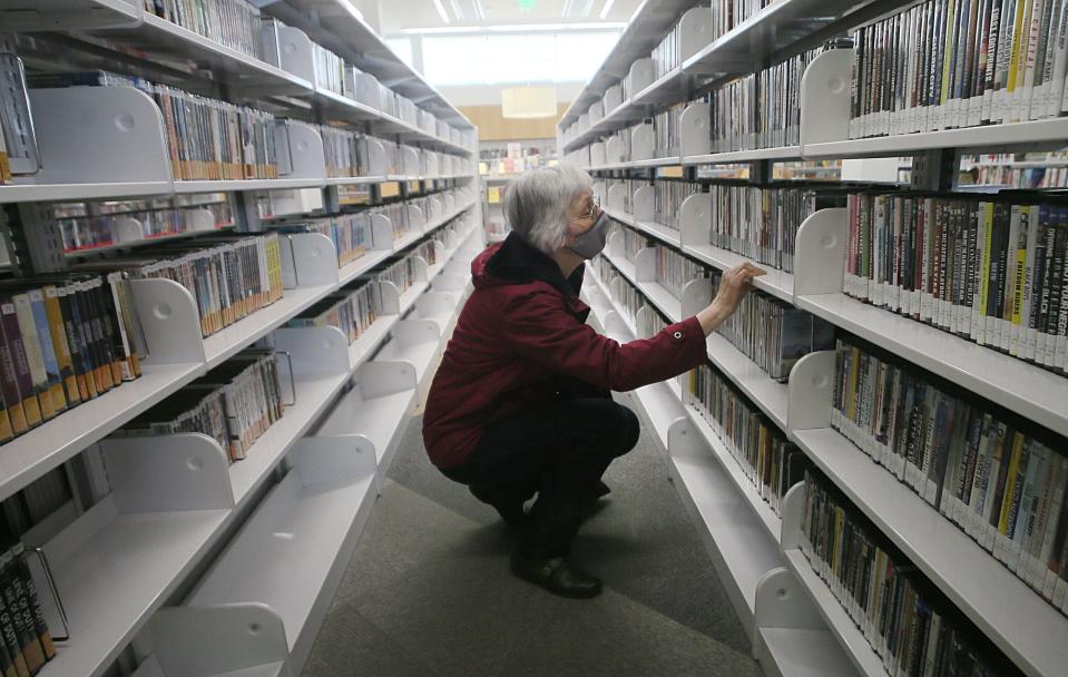 Bonnie Johnson from Ames, browses books at Ames Public Library on Thursday, Feb. 2, 2024, in, 2024, in Ames, Iowa.