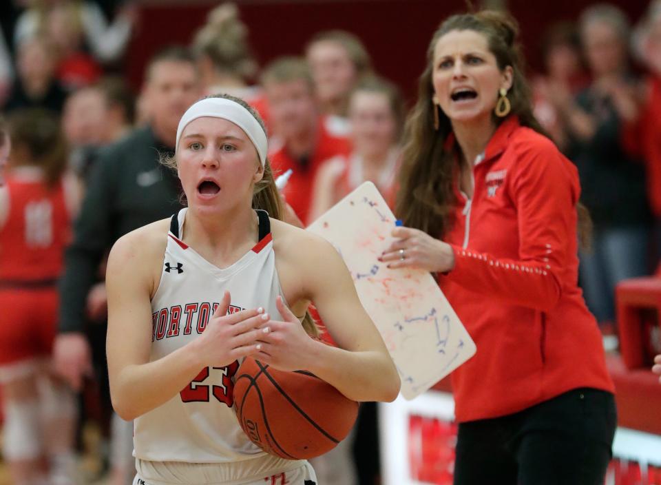 Hortonville High School's Kamy Peppler (23) and coach Celeste Ratka question an official on a traveling call when she was calling a timeout with 20 seconds left in the game and down by two points against Neenah High School during their WIAA Division 1 girls basketball sectional semifinal Thursday, March 3, 2022, at Kimberly High School in Kimberly, Wis. Neenah won, 65-60