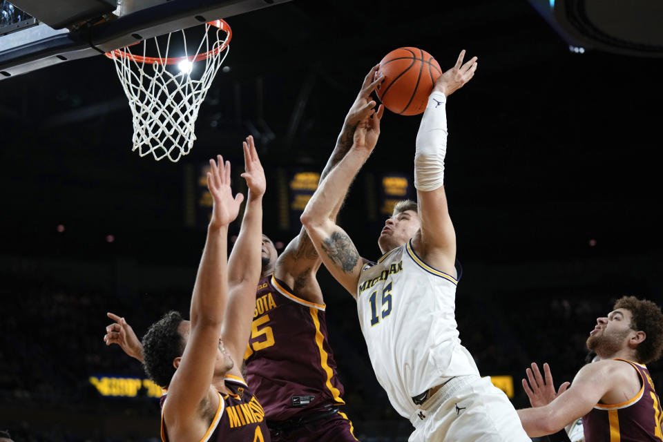 Minnesota guard Ta'lon Cooper (55) blocks a Michigan guard Joey Baker (15) shot in the second half of an NCAA college basketball game in Ann Arbor, Mich., Sunday, Jan. 22, 2023. (AP Photo/Paul Sancya)